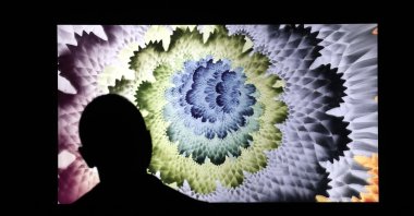 A man looks at a digital NFT artwork during a press preview at the grand opening of Superchief Gallery NFT in New York, U.S., March 25, 2021. (EPA Photo)