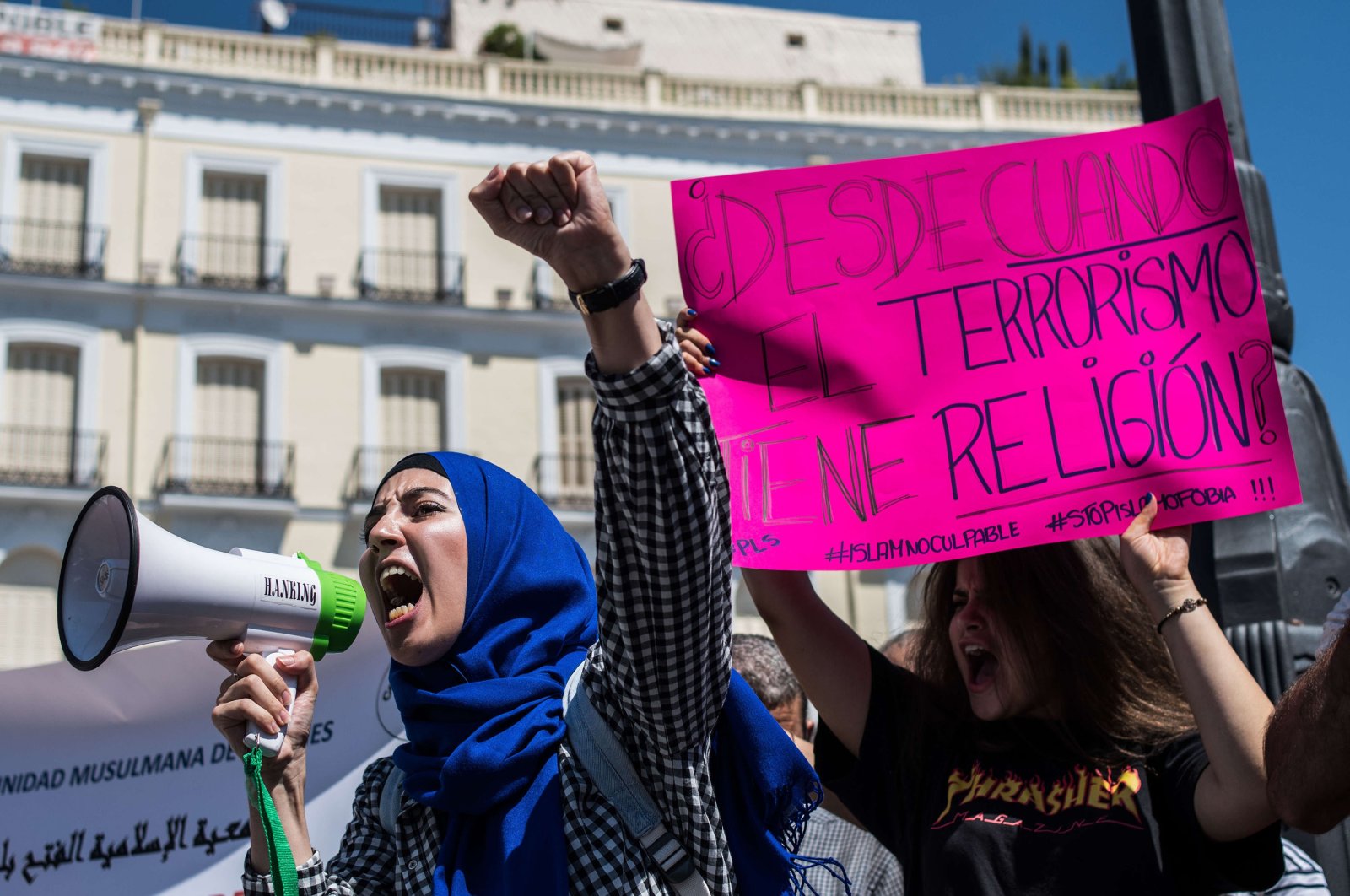 A woman uses a loudspeaker to call out slogans against terrorism with a placard in the background reading "Since when does terrorism have religion?" The Muslim community of Madrid gathered to reject terrorist attacks in Barcelona under the slogan "Not in my name," Madrid, Spain, Aug. 20, 2017. (Photo by Marcos del Mazo/LightRocket via Getty Images)