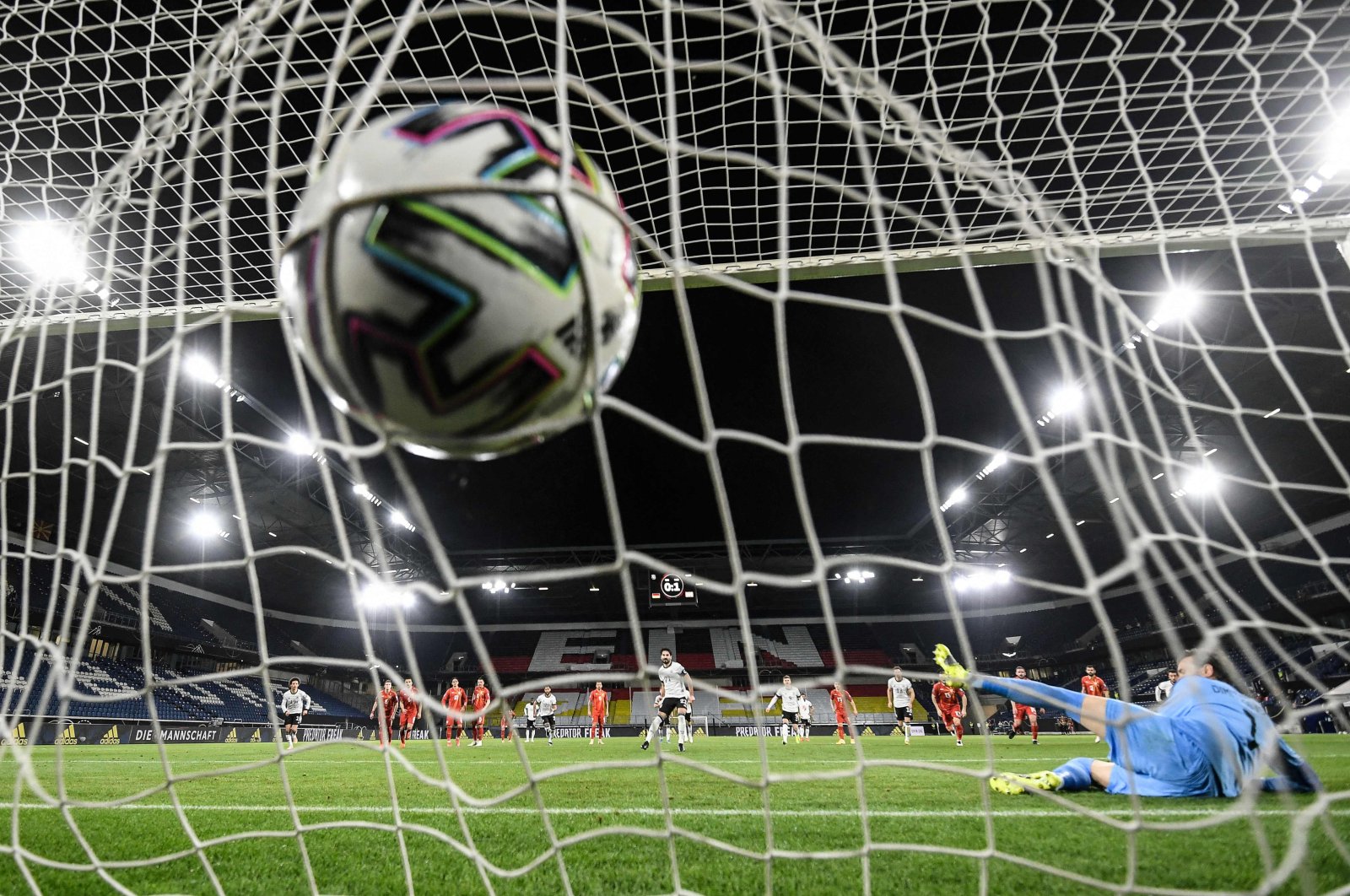 Germany's midfielder Ilkay Gundogan scores the 1-1 from the penalty spot past North Macedonia's goalkeeper Stole Dimitrievski (R) during the FIFA World Cup Qatar 2022 qualification football match Germany versus North Macedonia in Duisburg, western Germany, March 31, 2021. (AFP Photo)