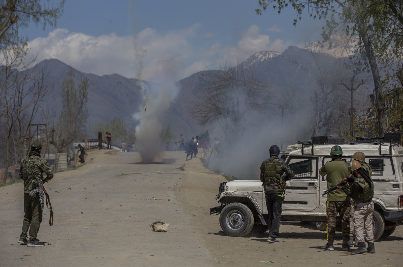 Indian police fire tear gas shells at Kashmiri villagers as they throw stones and bricks at them during a protest near the site of a gunbattle in Pulwama, south of Srinagar, Indian-controlled Kashmir, April 2, 2021. (AP Photo)