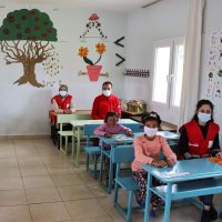 Turkish Red Crescent volunteers and children sit in a classroom in a freshly-painted school in Polatlı village near the Syrian border, Kilis, April 9, 2021. (AA) 