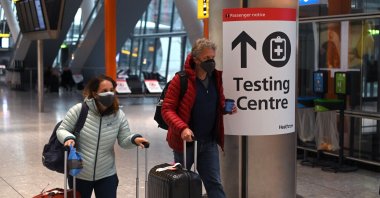 A sign directs passengers to a COVID-19 testing center at Terminal 5 of London Heathrow Airport in west London, the U.K., Feb. 9, 2021. (AFP Photo)