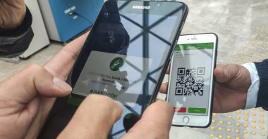 Security personnel checks the HES code of a citizen from the HES mobile app developed by the Health Ministry, Istanbul, Turkey, April 9, 2021. (DHA Photo)