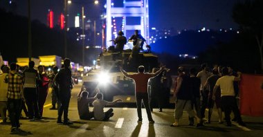 People take control of a tank near the Fatih Sultan Mehmet bridge during clashes with coup forces in Istanbul, Turkey, July 16, 2016. (AFP Photo)