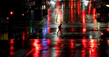 A man crosses Corrientes Avenue in Buenos Aires, Argentina, early Friday, April 9, 2021. (AP Photo)