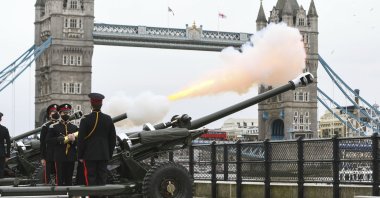 Members of the Honourable Artillery Company fire a 41-round gun salute from the wharf at the Tower of London, to mark the death of Prince Philip, London, U.K., Saturday, April 10, 2021. (PA via AP)