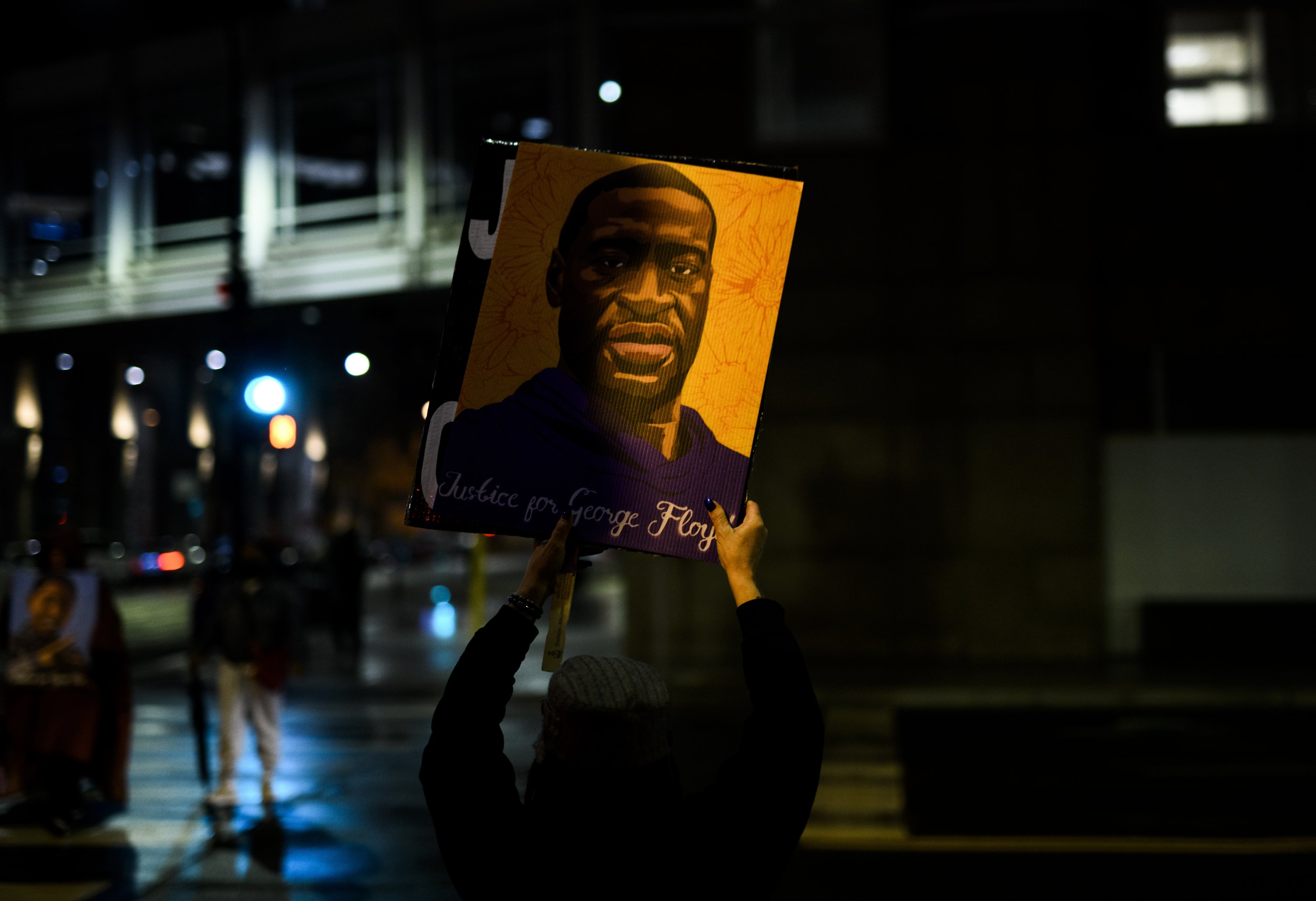 A woman holds up a portrait of George Floyd as people gather outside the Hennepin County Government Center to demand justice for his murder, in Minneapolis, Minnesota, U.S., April 9, 2021. (Photo by Getty Images)