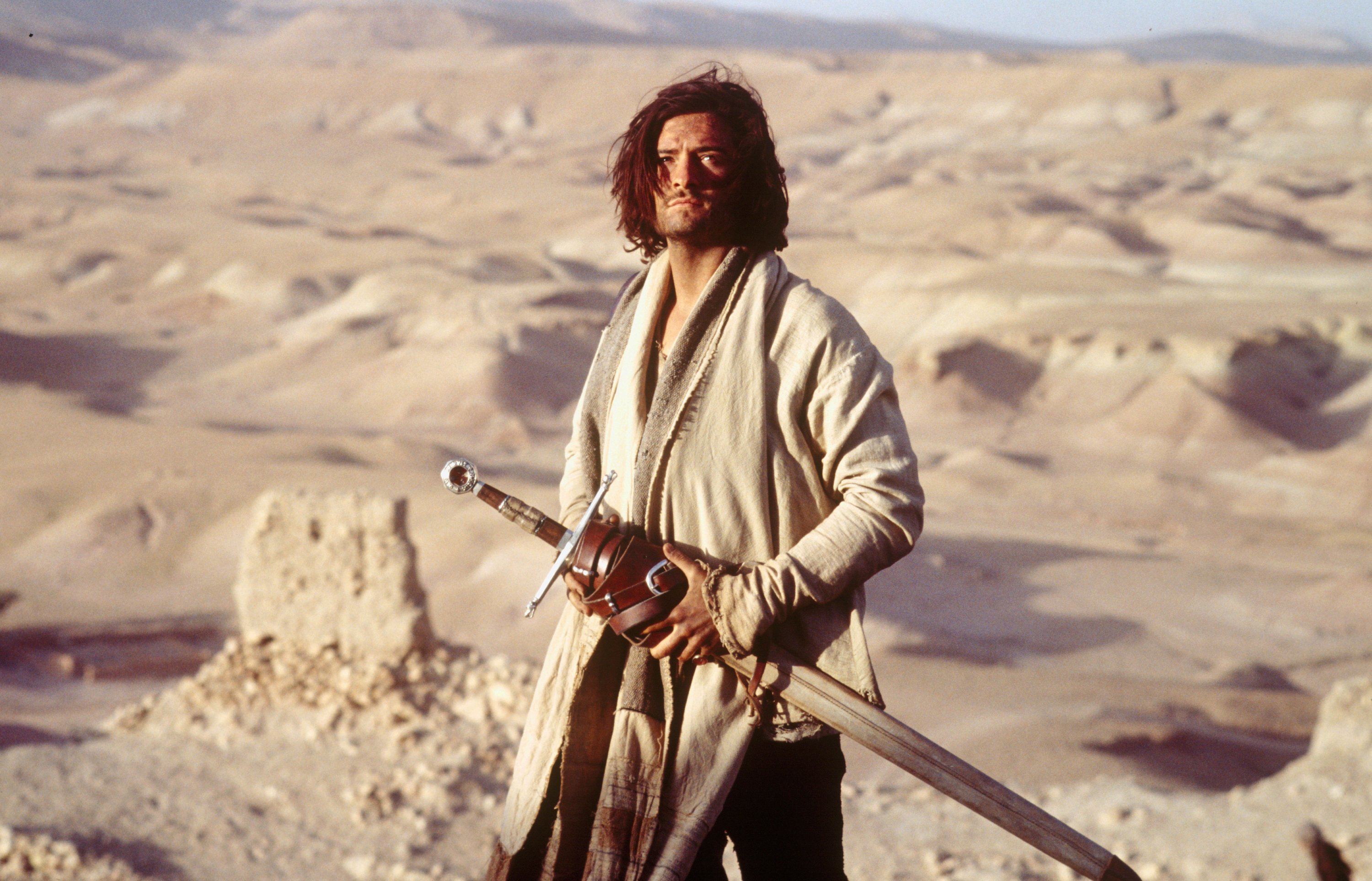 Orlando Bloom as Balian of Ibelin walks through a desert carrying nothing but his sword in a scene from the 2005 film “Kingdom of Heaven.” (Archive Photo)