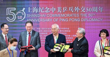 U.S. Consul General in Shanghai James Heller (2nd L) with former Chinese table tennis players and "ping-pong diplomacy" participants Zhang Xielin (C) and Zheng Minzhi (R) receiving souvenirs during a ceremony to mark the 50th anniversary of the diplomatic event at the International Table Tennis Federation museum in Shanghai, April 10, 2021. (AFP Photo)