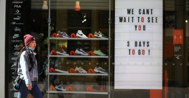 A pedestrian walks by a store being prepared for the reopening, as the coronavirus lockdown restrictions begin to ease, in London, Britain, April 9, 2021. (Reuters Photo)