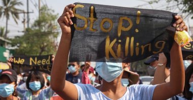 Demonstrators hold banners during an anti-military coup protest in Mandalay, Myanmar, April 11, 2021. (EPA Photo)