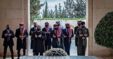 Prince Hamzah (2nd-L), Jordanian King Abdullah II (C) and Crown Prince Hussein (R) stand next to the tomb of the late King Hussein at Raghadan Palace in the capital Amman, Jordan, April 11, 2021. (Handout picture released by the Jordanian Royal Palace/ AFP Photo)