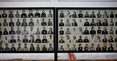 A visitor looks at pictures of victims of the Khmer Rouge regime at the former notorious Tuol Sleng prison that is now the Genocide Museum, in Phnom Penh, Cambodia, Aug. 5, 2014. (Reuters File Photo)