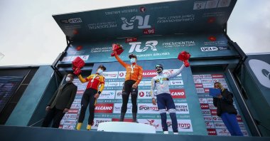 Winners of the bunch sprint event in the opening stage of the Tour of Turkey, Dutch rider Arvid de Kleijn of Rally Cycling (C), Norway's Kristoffer Halvorsen'e (2nd L) and France's Pierre Barbier (R) are accompanied by Turkey's Sports Minister Mehmet Muharrem Kasapoğlu, Konya, central Turkey, Sunday, April 11, 2021.