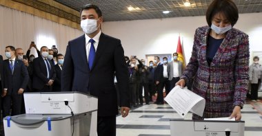 Kyrgyzstan's President Sadyr Japarov and his wife Aigul Asanbaeva cast their ballots at a polling station during the referendum in Bishkek, Kyrgyzstan, April 11, 2021. (AP Photo)