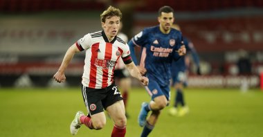Sheffield United's Ben Osborn, left, controls the ball during the English Premier League soccer match between Sheffield United and Arsenal at the Bramall Lane stadium in Sheffield, England, Sunday, April 11, 2021. (AP Photo)