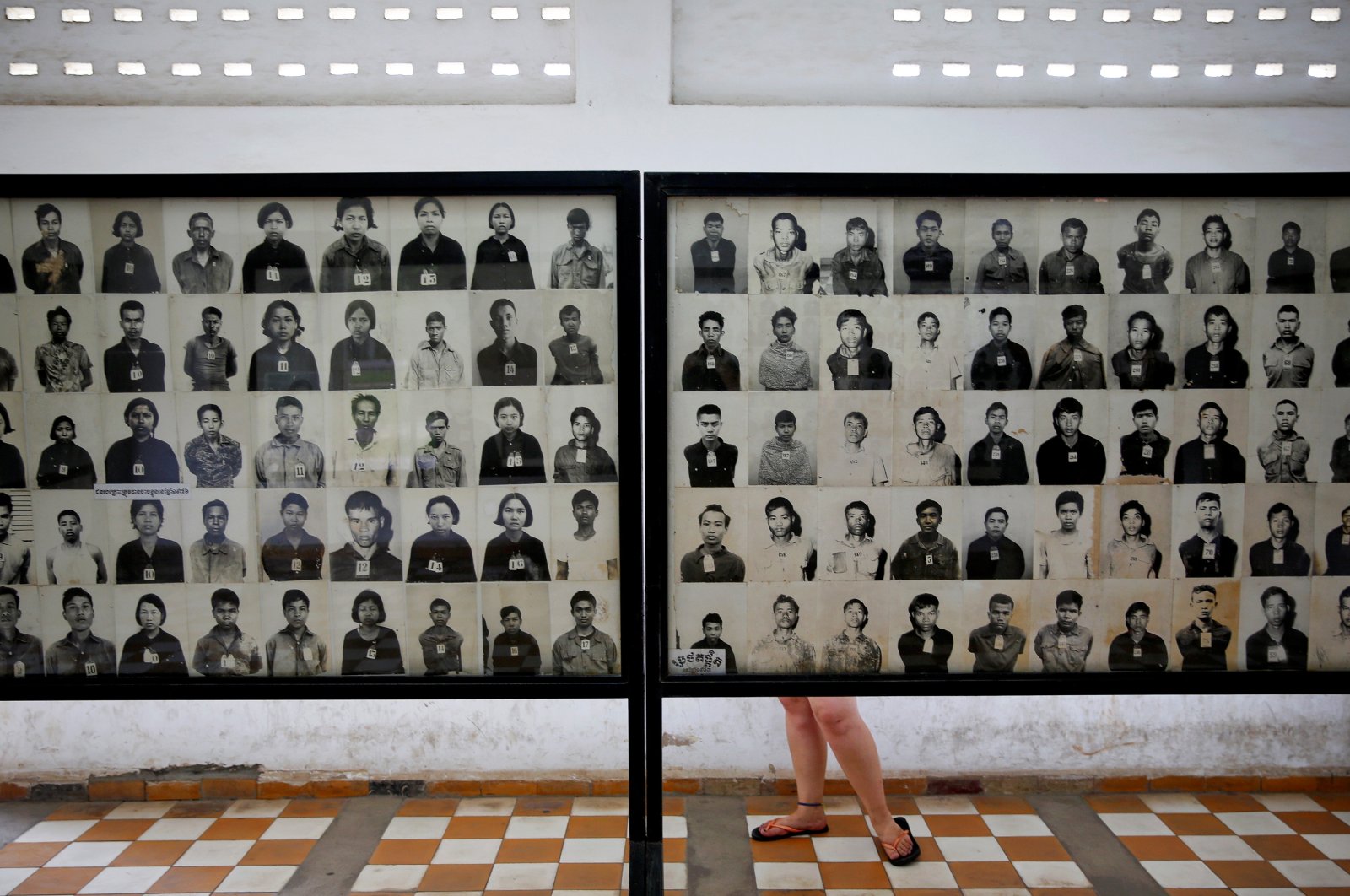 A visitor looks at pictures of victims of the Khmer Rouge regime at the former notorious Tuol Sleng prison that is now the Genocide Museum, in Phnom Penh, Cambodia, Aug. 5, 2014. (Reuters File Photo)