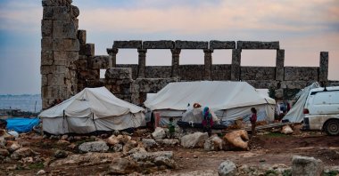 A group of displaced Syrians at their makeshift tents set up at the Dana ancient site, Idlib, northern Syria, Dec. 20, 2020. (Photo by Getty Images)