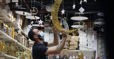 A vendor decorates his shop at a market a day before the start of the holy month of Ramadan in Kuwait City, Kuwait, April 12, 2021. (AFP Photo)