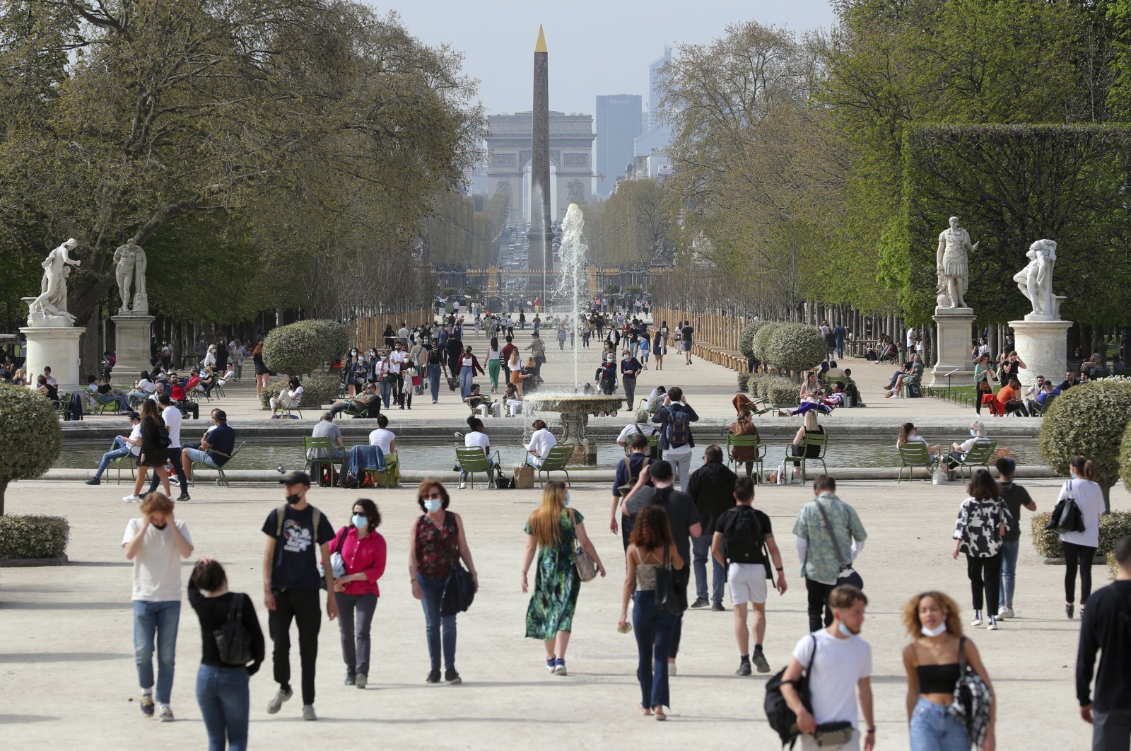 In this file photo, people wear face masks as they walk in the Tuileries garden in Paris, France, April 1, 2021. (AP Photo)