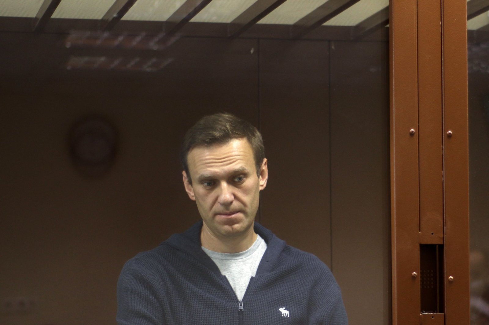 Russian opposition leader Alexei Navalny, standing inside a glass cell during a court hearing in Moscow, Russia, on Feb. 12, 2021. (AFP)