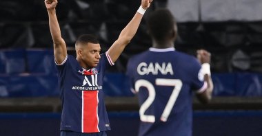 PSG's French forward Kylian Mbappe (L) and Senegalese midfielder Idrissa Gueye celebrate after winning the UEFA Champions League quarterfinal second leg football match against Bayern Munich at the Parc des Princes stadium in Paris, France, April 13, 2021. (AFP Photo)