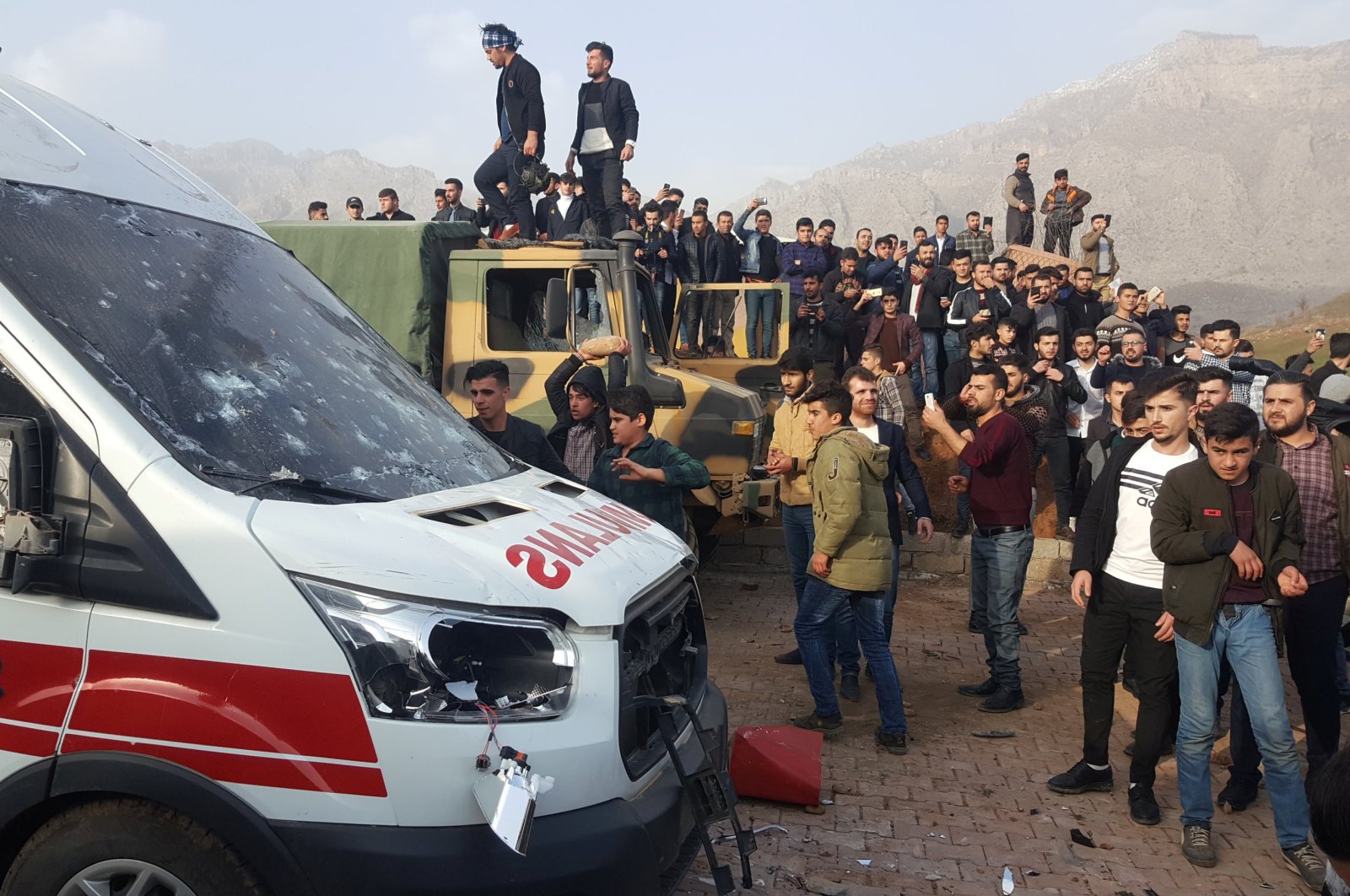 Protesters provoked by the PKK gather after storming a Turkish military camp near Dohuk, Iraq, Jan.26, 2019.  