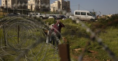 Palestinian laborers head home after their workday at construction projects in the West Bank Jewish settlement of Efrat, March 16, 2021. (AP Photo)