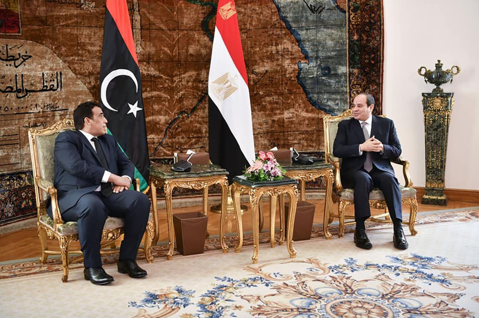 A handout picture received from the Egyptian presidency shows Egypt's President Abdel Fattah el-Sissi (R) during a meeting with the chairperson of Libya's presidency council, Mohamed al-Manfi, in Cairo, Egypt, March 25, 2021. (AFP Photo)