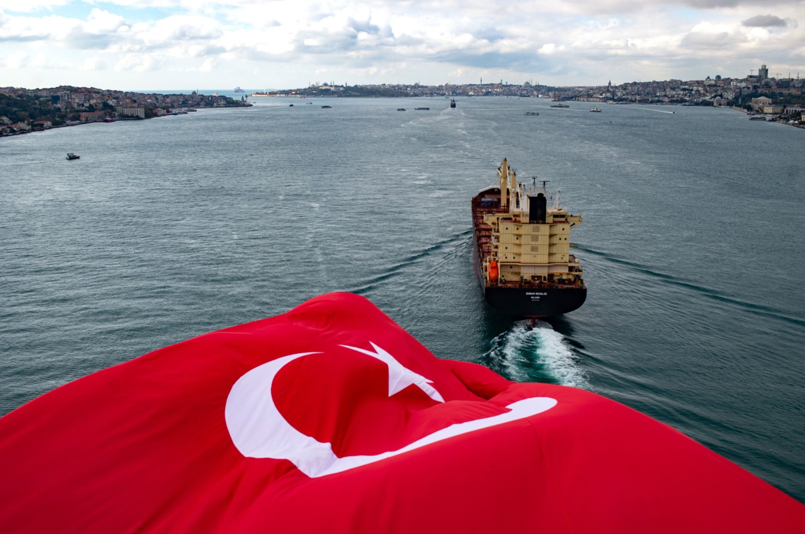 The Turkish national flag waves on the July 15 Martyrs' Bridge, formerly known as the Bosporus Bridge, as a ship sails through the Bosporus, in Istanbul, Turkey Nov. 8, 2020. (AFP Photo)