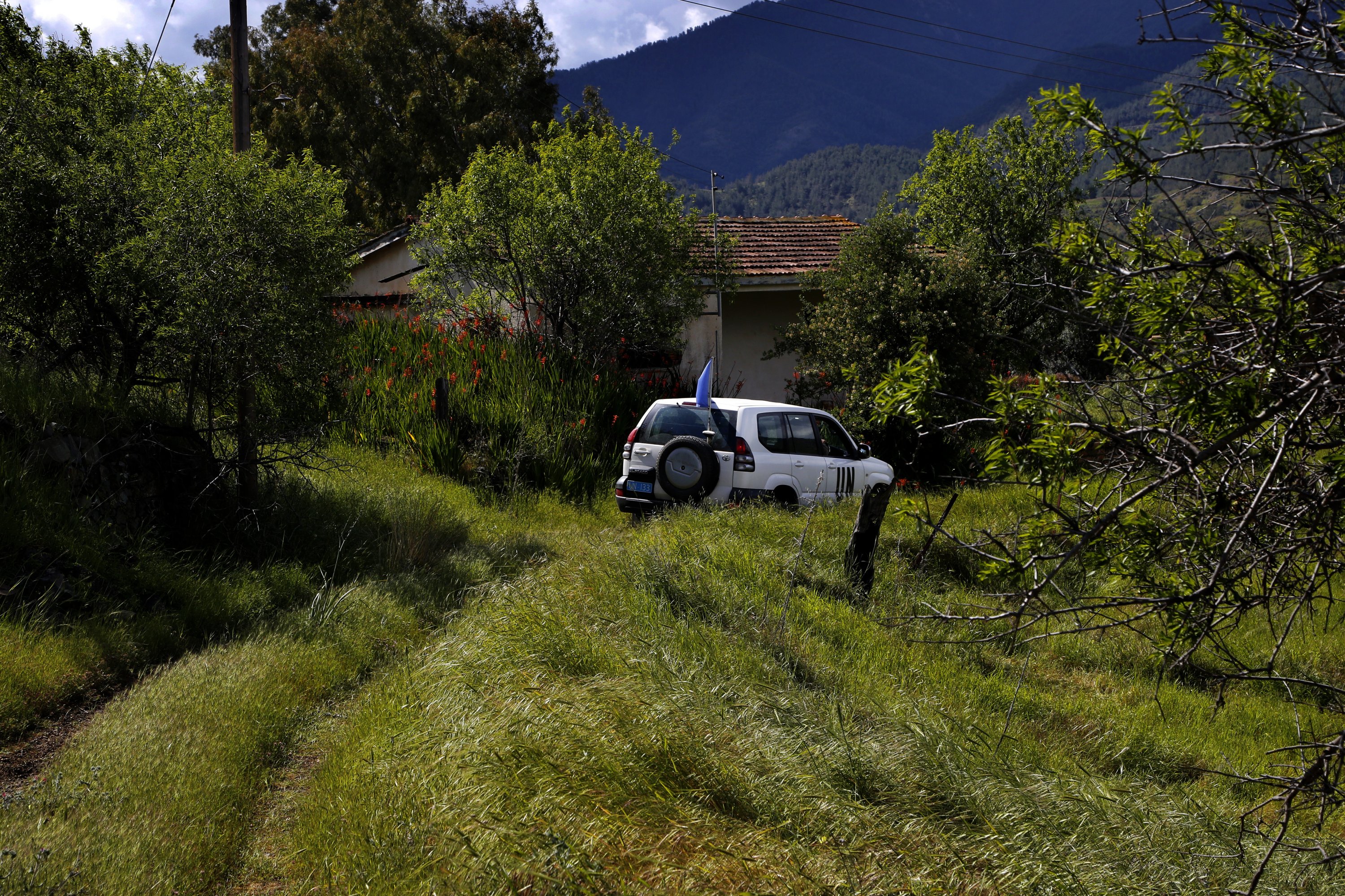 A U.N. vehicle drives through the abandoned village of Varisia inside the U.N.-controlled buffer zone that divides the Greek-controlled south and the Turkish-controlled north, on the island of Cyprus, March 26, 2021. (AP Photo)
