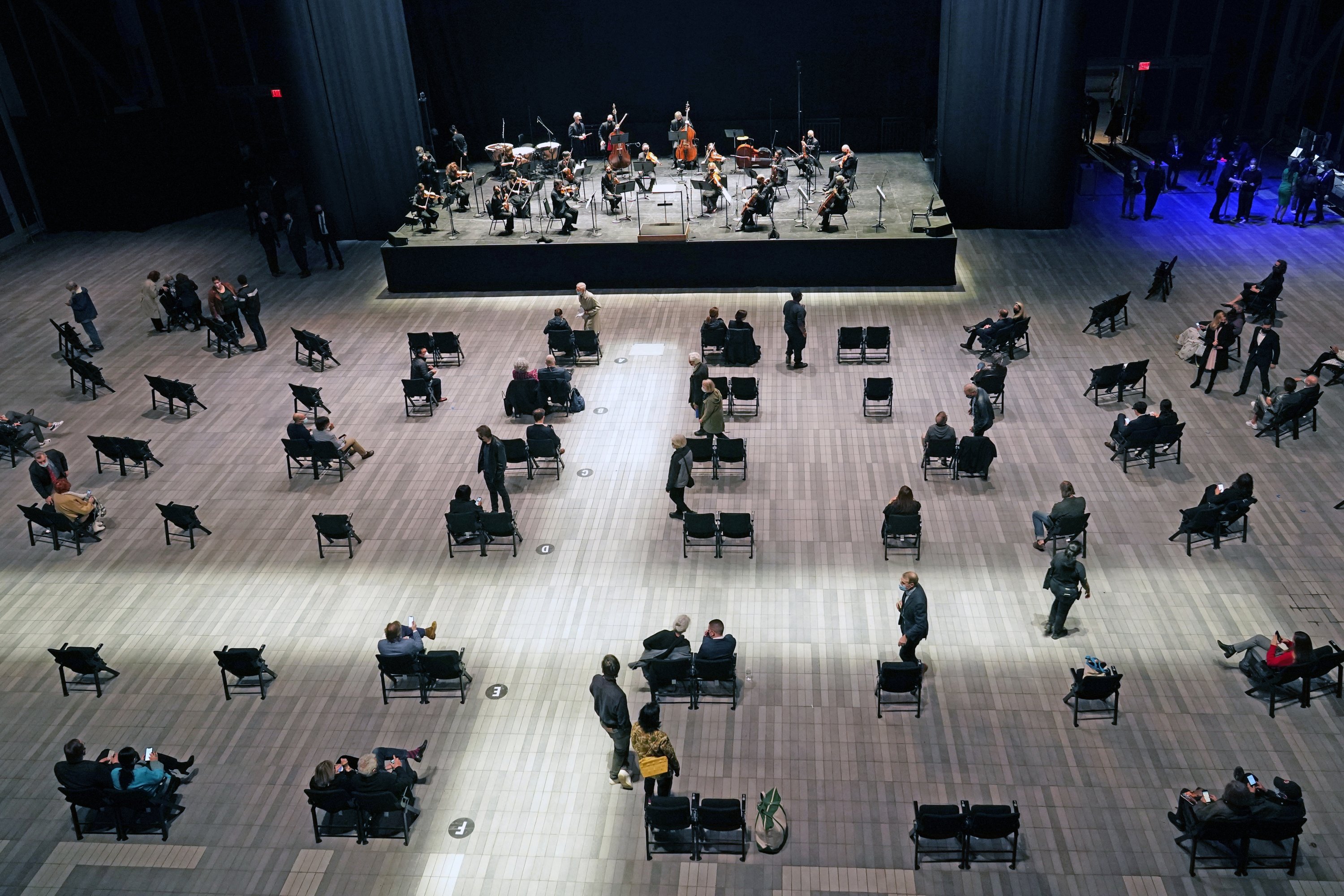 Concertgoers take their seats before a live performance of the New York Philharmonic, which performed for the first time since March 10, 2020, at The Shed in Hudson Yards, New York, U.S., Wednesday, April 14, 2021. (AP Photo)