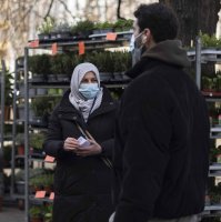 Aliye Türkyılmaz (L), a member of a multilingual team of five street vendors, stands in a market in Berlin, Germany, March 9, 2021. (AP Photo)