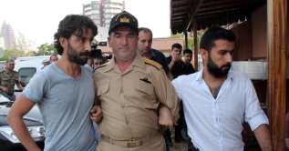 Police officers escort FETÖ member Rear Admiral Nejat Atilla Demirhan after the July 15 coup attempt, southern Mersin province, Turkey. (IHA Photo)