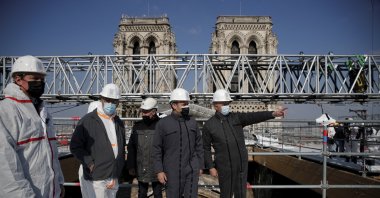 French President Emmanuel Macron (C) visits the reconstruction site of the Notre Dame cathedral, Paris, France, April 15, 2021. (Pool via AP)