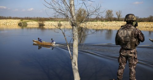 Fishermen sail along the Maritsa river as a Turkish special forces team patrols the Turkish-Greek border near Karpuzlu village, in the Edirne region, Turkey, Wednesday, March 11, 2020. (AP File Photo)