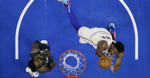 Philadelphia 76ers' Joel Embiid (R) goes up for a shot against Brooklyn Nets' Jeff Green during an NBA game, Philadelphia, U.S. April 14, 2021. (AP Photo)