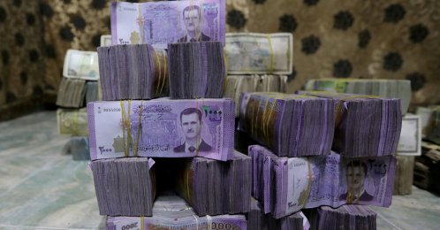 Syrian pounds are stacked inside an exchange currency shop in Azaz, Syria, Feb. 3, 2020. (REUTERS)