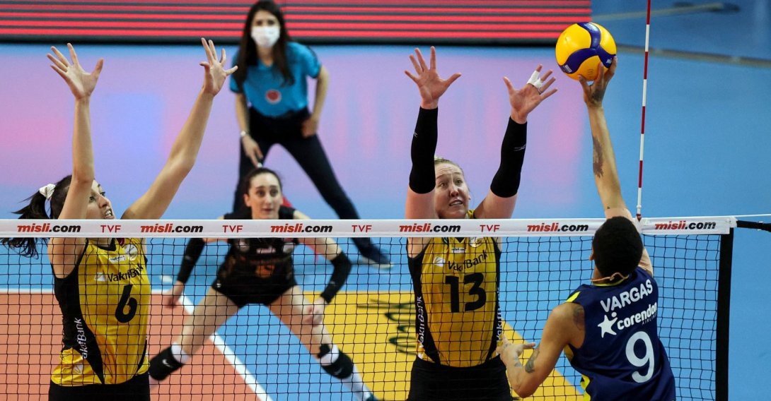 VakıfBank's Kübra Çalışkan (L, #6) and Mic Bartsch (2nd from R, #13) jump to make a play against Fenerbahçe Opet's Melissa Vargas (R, #9) during a Misli.com Sultans' League playoff game in Istanbul, Turkey, April 13, 2021. (AA Photo)