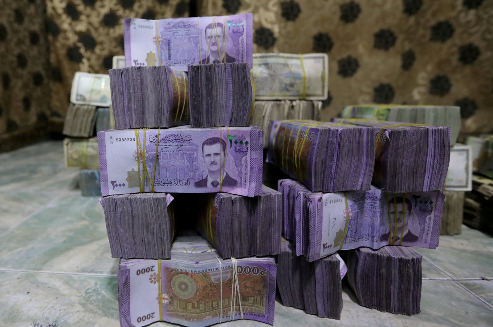 Syrian pounds are stacked inside an exchange currency shop in Azaz, Syria, Feb. 3, 2020. (REUTERS)