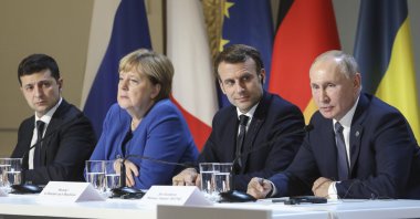 From left to right, Ukrainian President Volodymyr Zelenskiy, German Chancellor Angela Merkel, French President Emmanuel Macron and Russian President Vladimir Putin attend a joint news conference at the Elysee Palace in Paris, France, Dec. 9, 2019. (AP Photo)