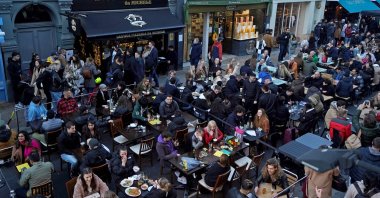 People eating and drinking in London's Soho following step two of the British government's roadmap out of England's third national lockdown, London, U.K., April 16, 2021 (AFP Photo)