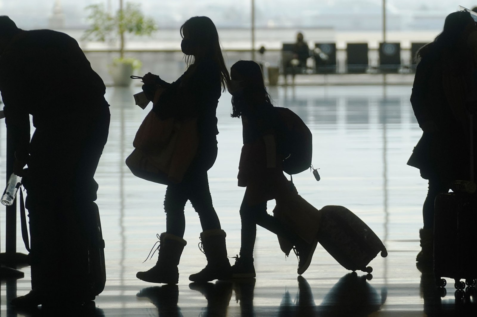 In this March 17, 2021, file photo, travelers walk through the Salt Lake City International Airport, in Salt Lake City, U.S.. (AP Photo)