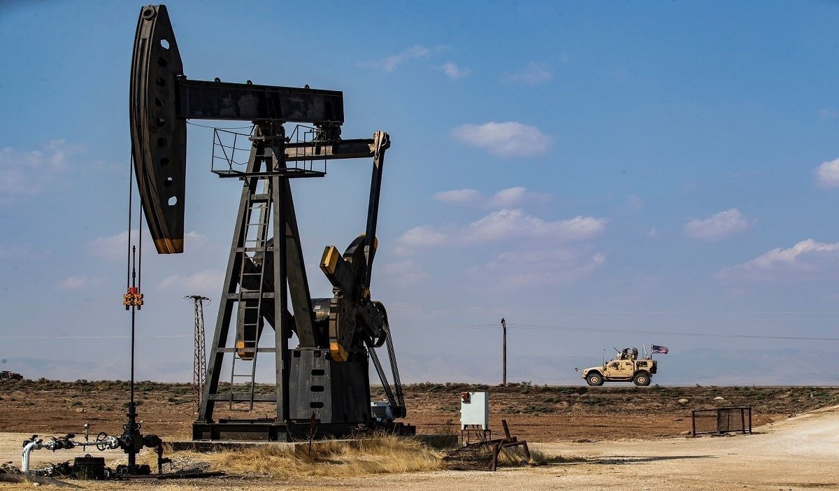 A United States military vehicle drives past an oil pump jack in the countryside of Syria's northeastern city of Qamishli, Oct. 26, 2019. (AFP Photo)