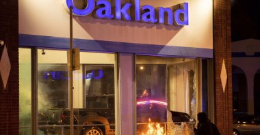 Demonstrators set fires at a Honda dealership during a protest against police brutality in Oakland, California, U.S., April 16, 2021. (AP Photo)