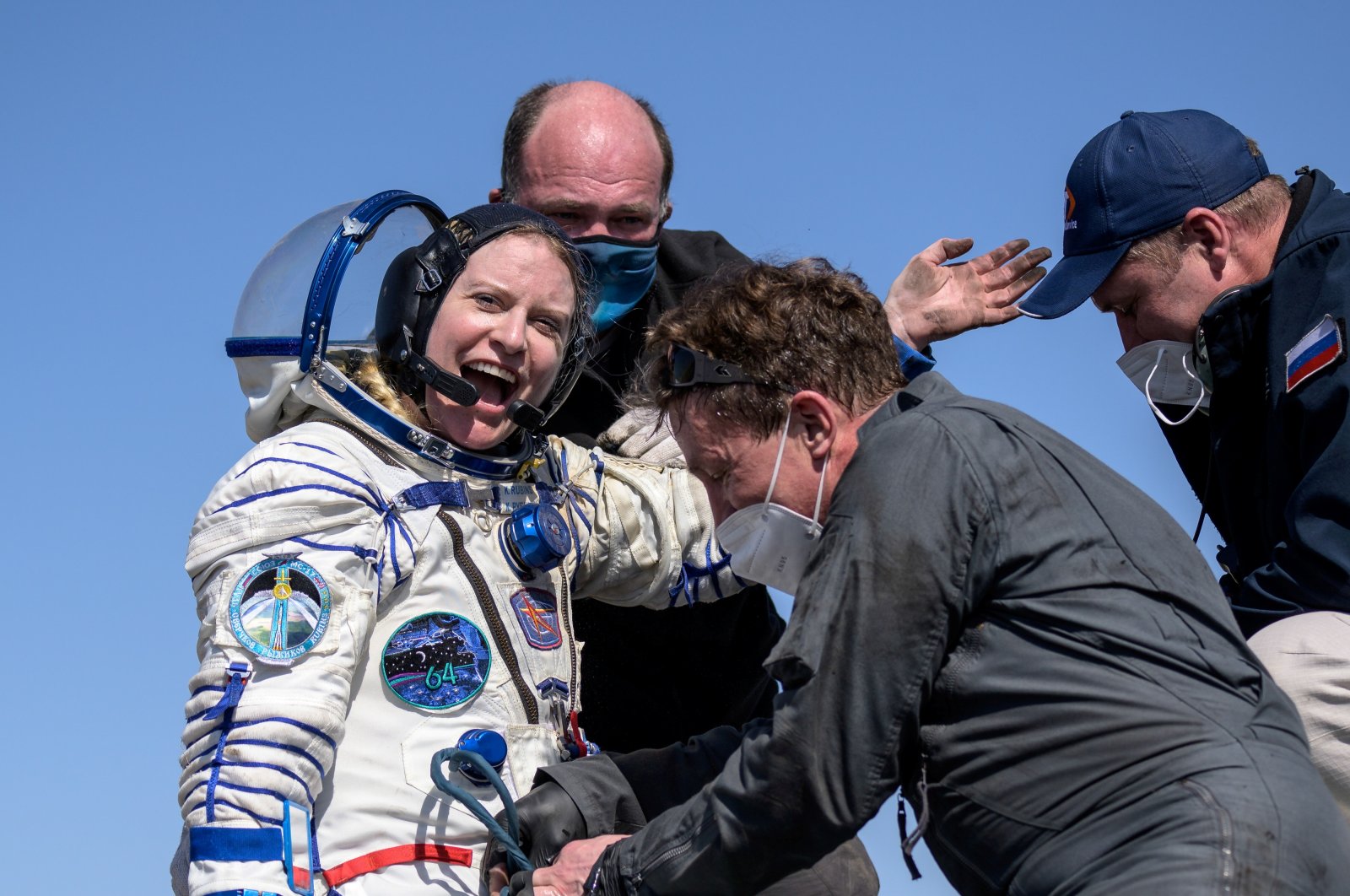 The International Space Station (ISS) crew member Kathleen Rubins of NASA reacts shortly after the landing of the Soyuz MS-17 space capsule in a remote area outside Zhezkazgan, Kazakhstan, April 17, 2021. (NASA/Bill Ingalls/via Reuters)
