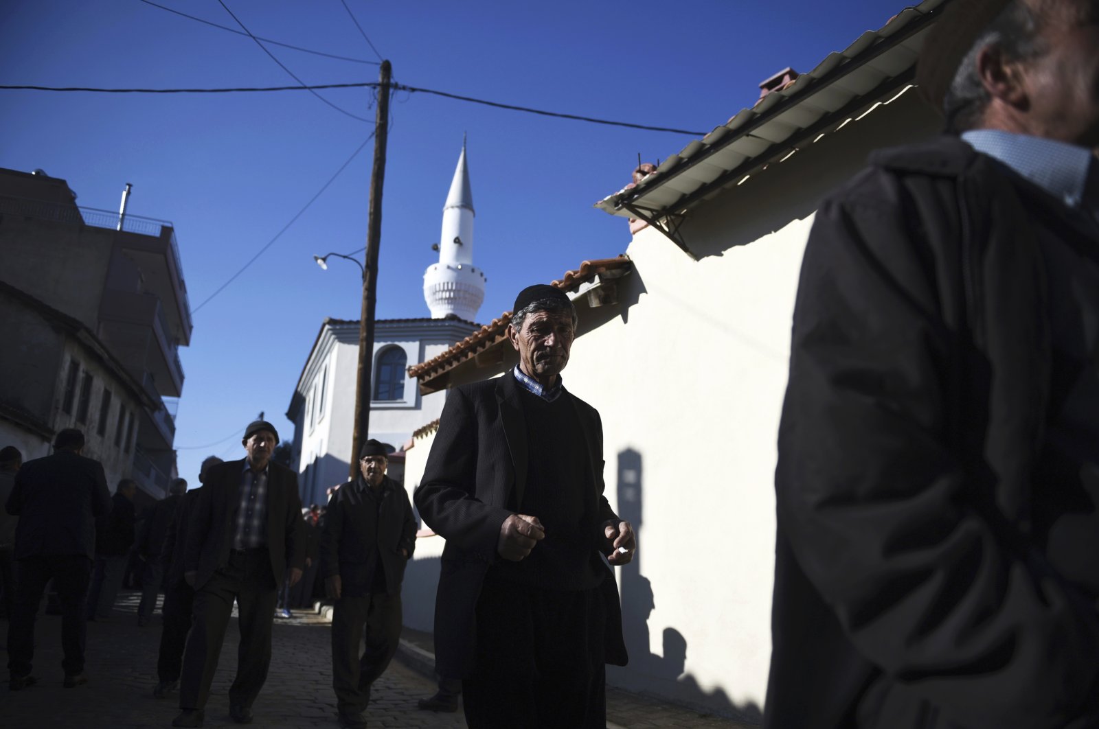 People walk outside the Kirmahalle Cammi mosque in Komotini, northeastern Greece, Dec. 8, 2017. (AP Photo)