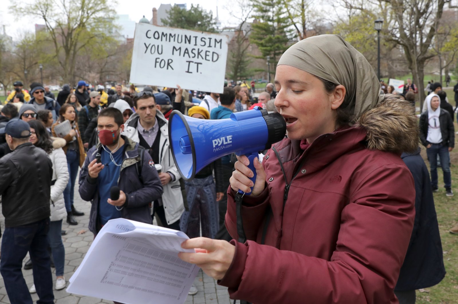A demonstrator speaks through a megaphone during a protest against new coronavirus disease (COVD-19) restrictions, in Toronto, Canada, April 17, 2021. (REUTERS Photo)