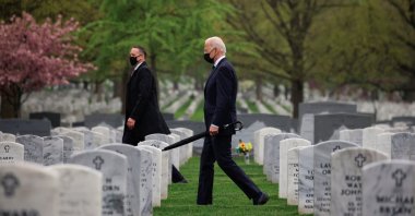U.S. President Joe Biden carries an umbrella as he walks among graves in a visit to pay his respects to fallen veterans of the Afghan conflict, in Arlington National Cemetery in Arlington, Virginia, U.S., April 14, 2021. (Reuters Photo)
