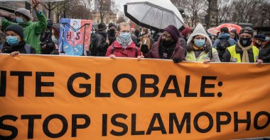 Protestors hold a banner at a demonstration against the draft global security bill and growing Islamophobia in Paris, France, Dec. 12, 2020. (Getty Images)